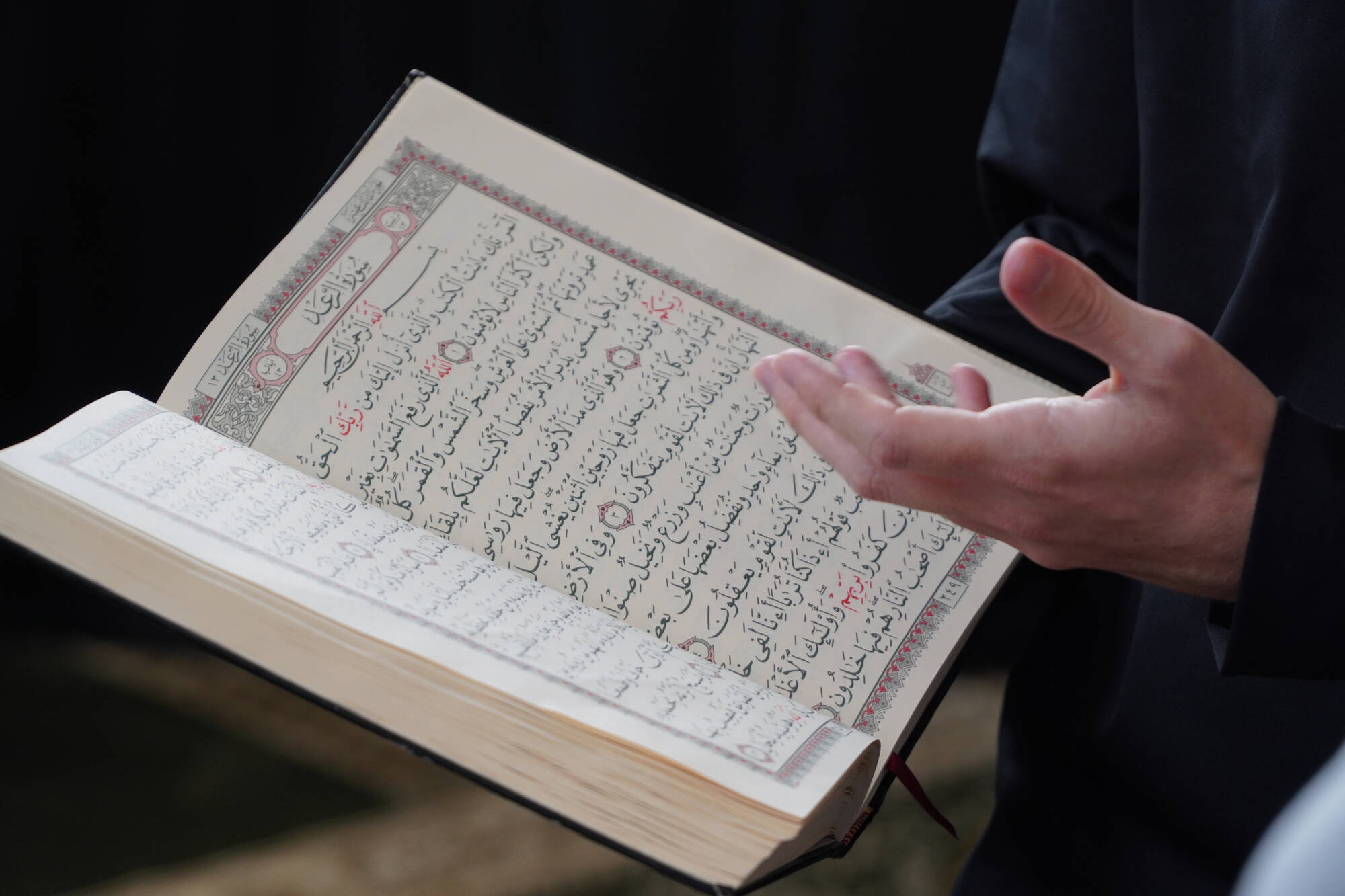 A close-up picture of a Qur'an in a person's hands